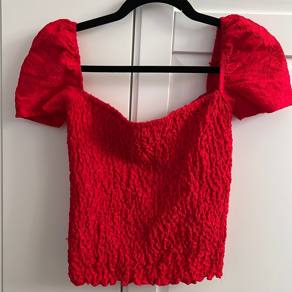 Express puff sleeves, square neck, smocked top.